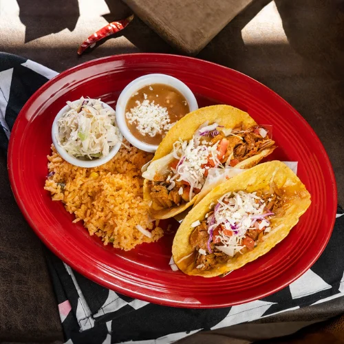 Pork Carnitas Tacos - Slow-cooked, tender pork carnitas served in warm corn tortillas with fresh cilantro, onions, and salsa verde.